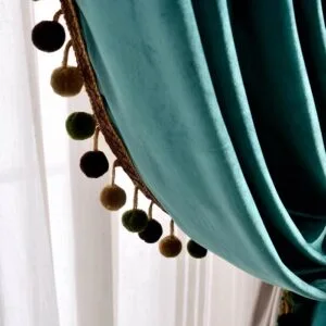 green velvet curtain with pom-pom edge trim