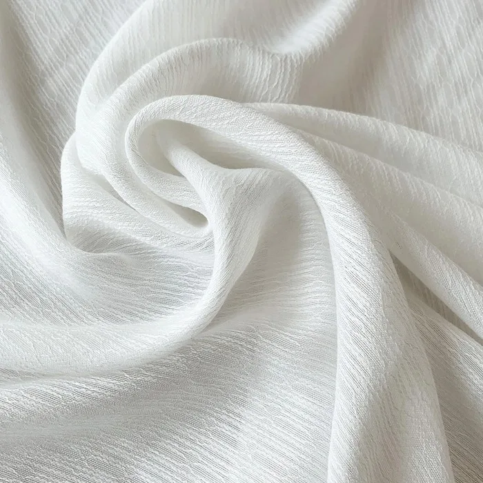 white sheer fabric folded to show linear texture
