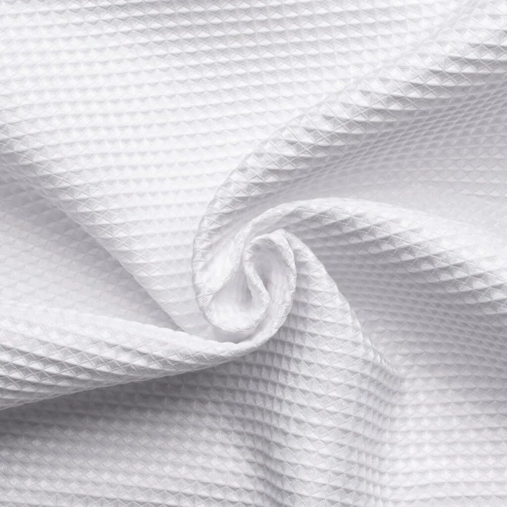 white waffle-weave fabric folded into a swirl
