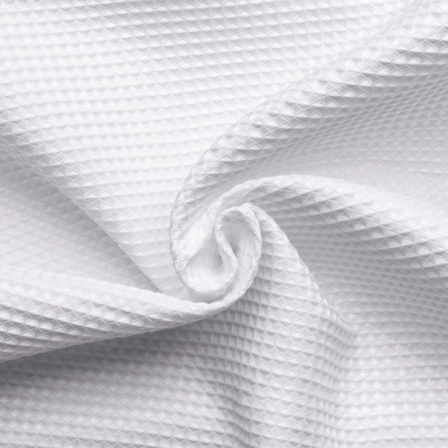 white waffle-weave fabric folded into a swirl