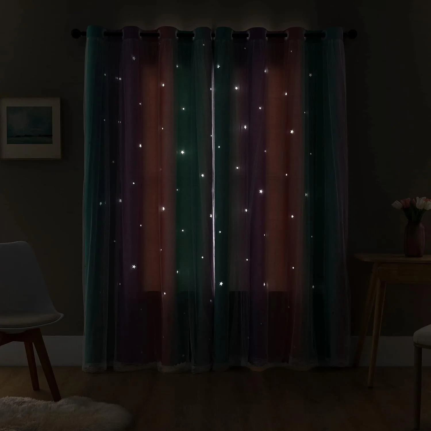 star cut-outs glowing through pastel curtains in a dark room