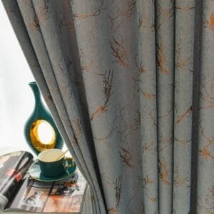 gold foil printed blackout curtain beside a window