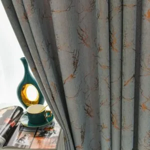 gold foil printed blackout curtain beside a window