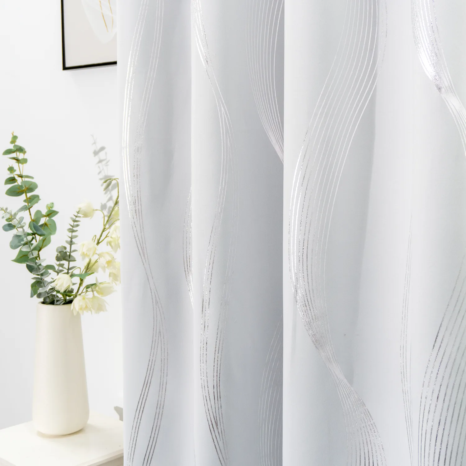 silver linear foil curtain beside a vase