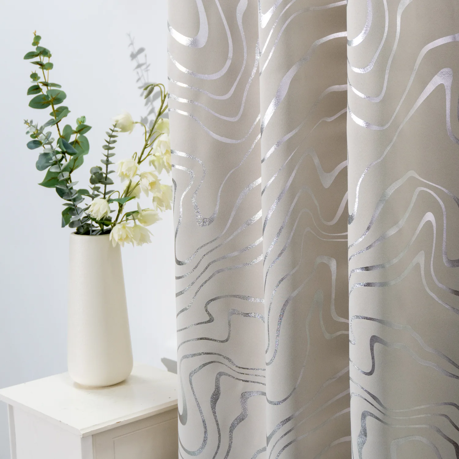 silver wavy foil curtain beside a vase