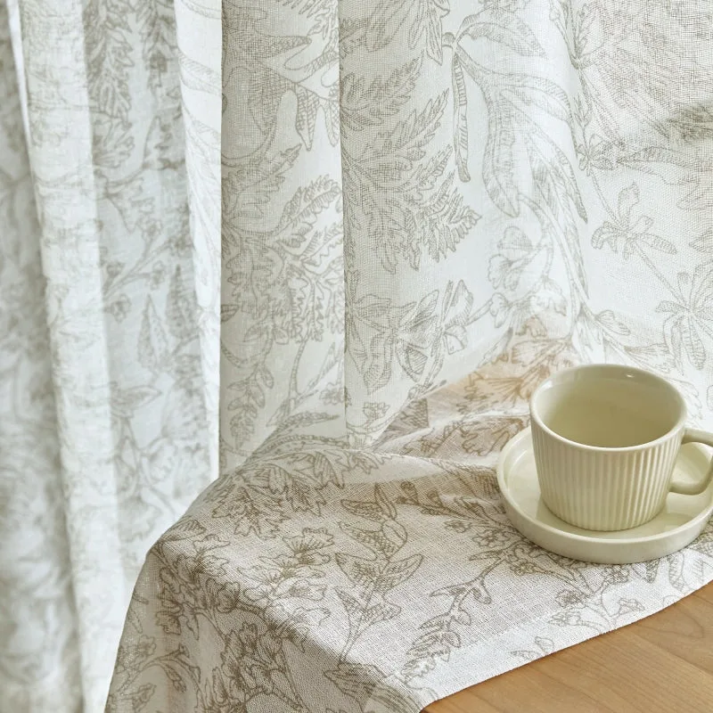 botanical printed sheer curtain draped over a table