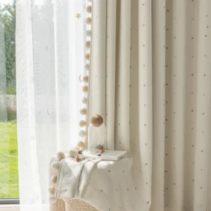 beige polka dot blackout curtain with pom-pom trim