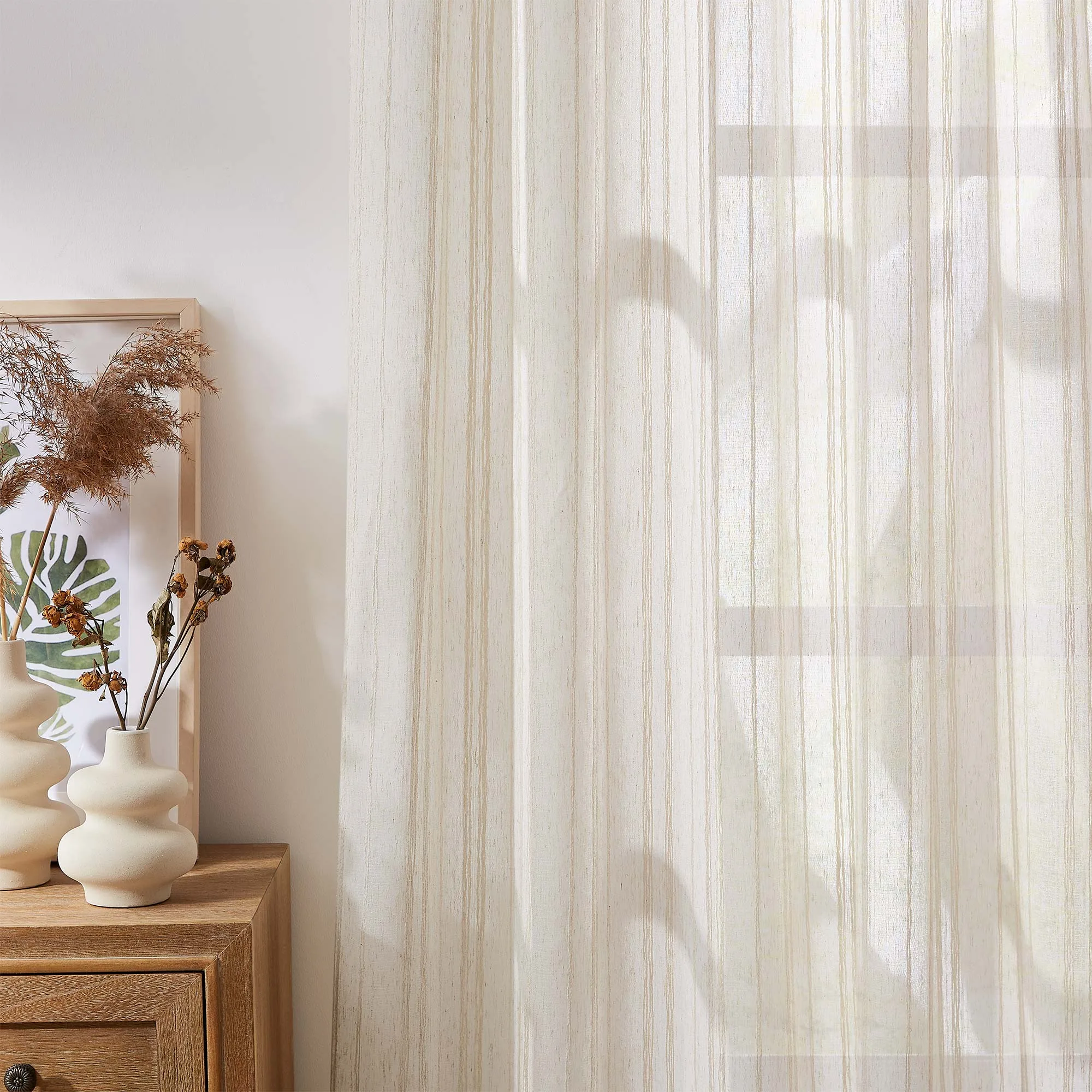 wave-pattern sheer curtain beside a window
