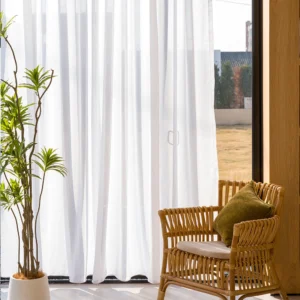 white faux linen sheer curtains beside a glass door