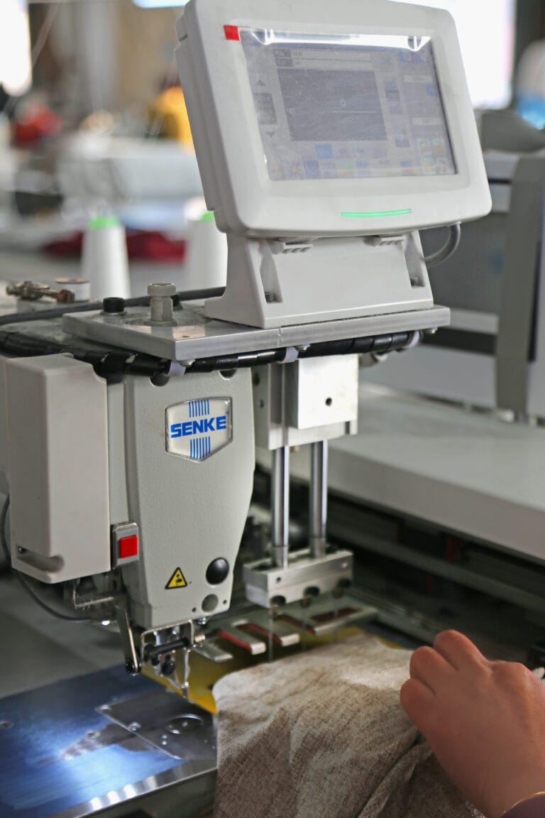Pleating machine setting pleat spacing on curtain fabric