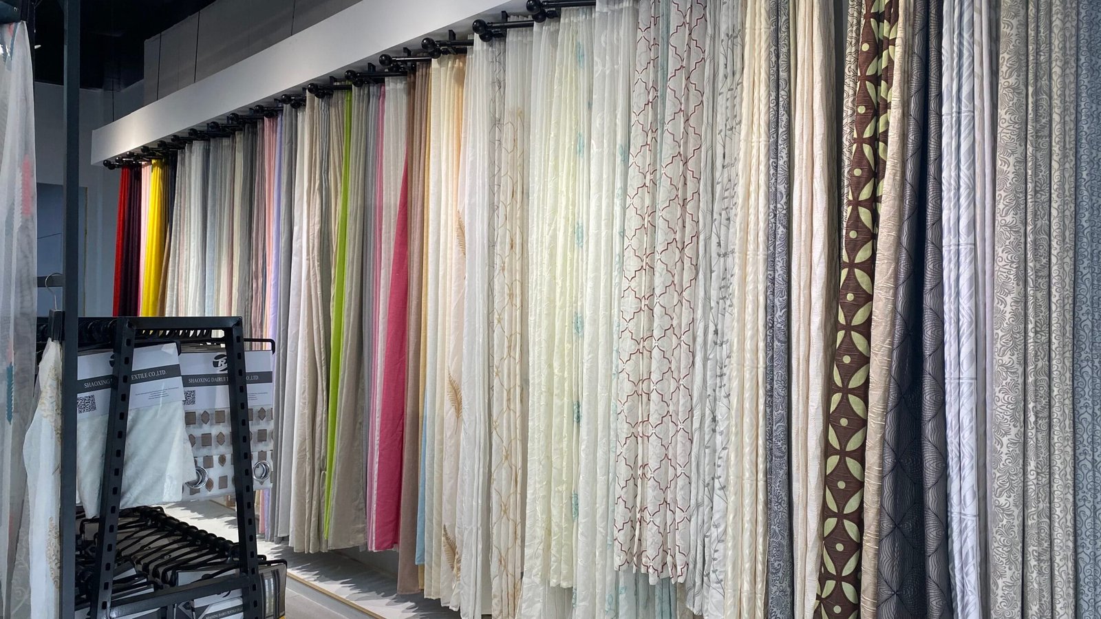 Assorted finished curtain samples in many colors at a wholesale supplier