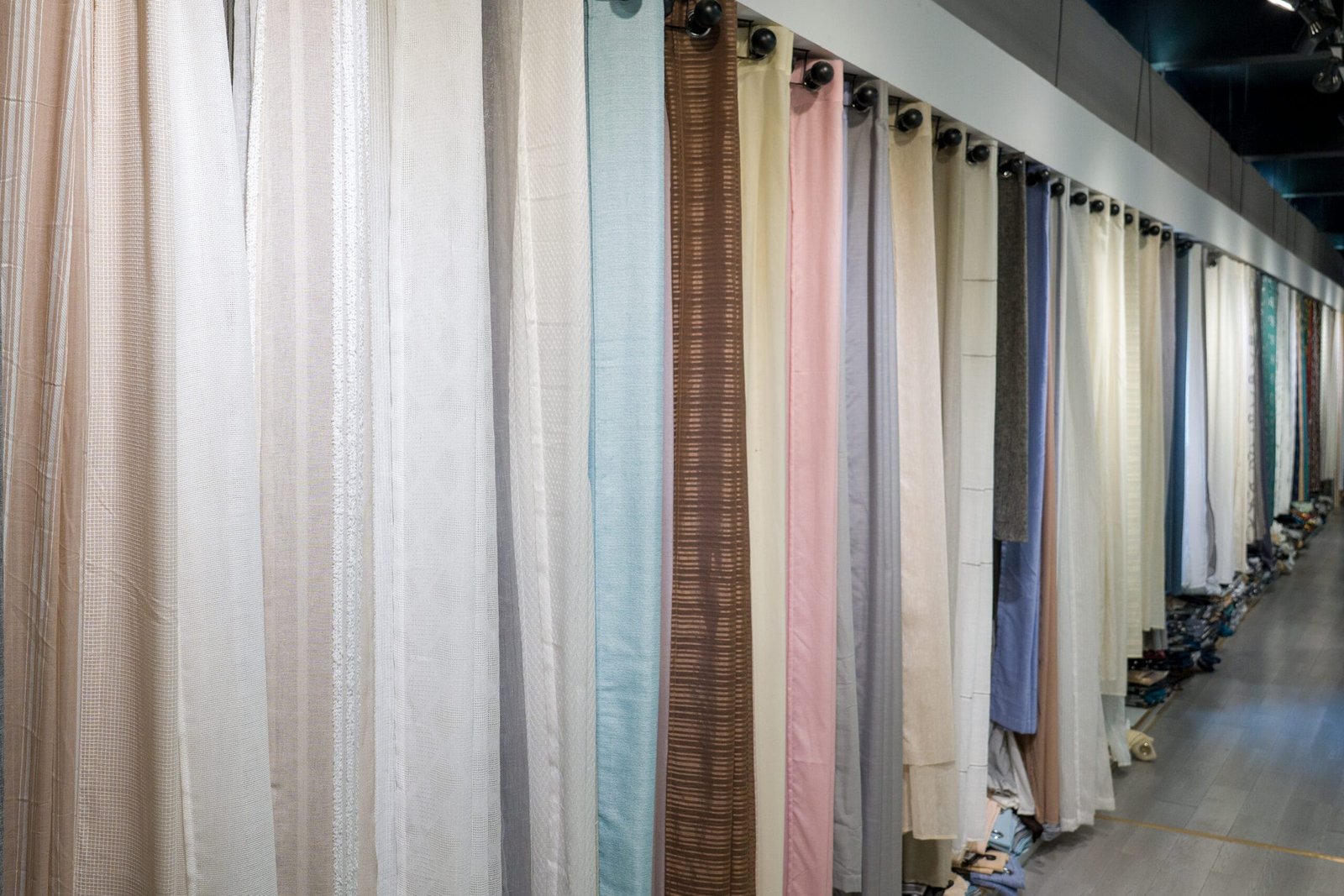Mid-weight linen-look curtain fabrics displayed in a wholesale showroom