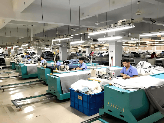 Curtain sewing and finishing workshop with production lines and workers