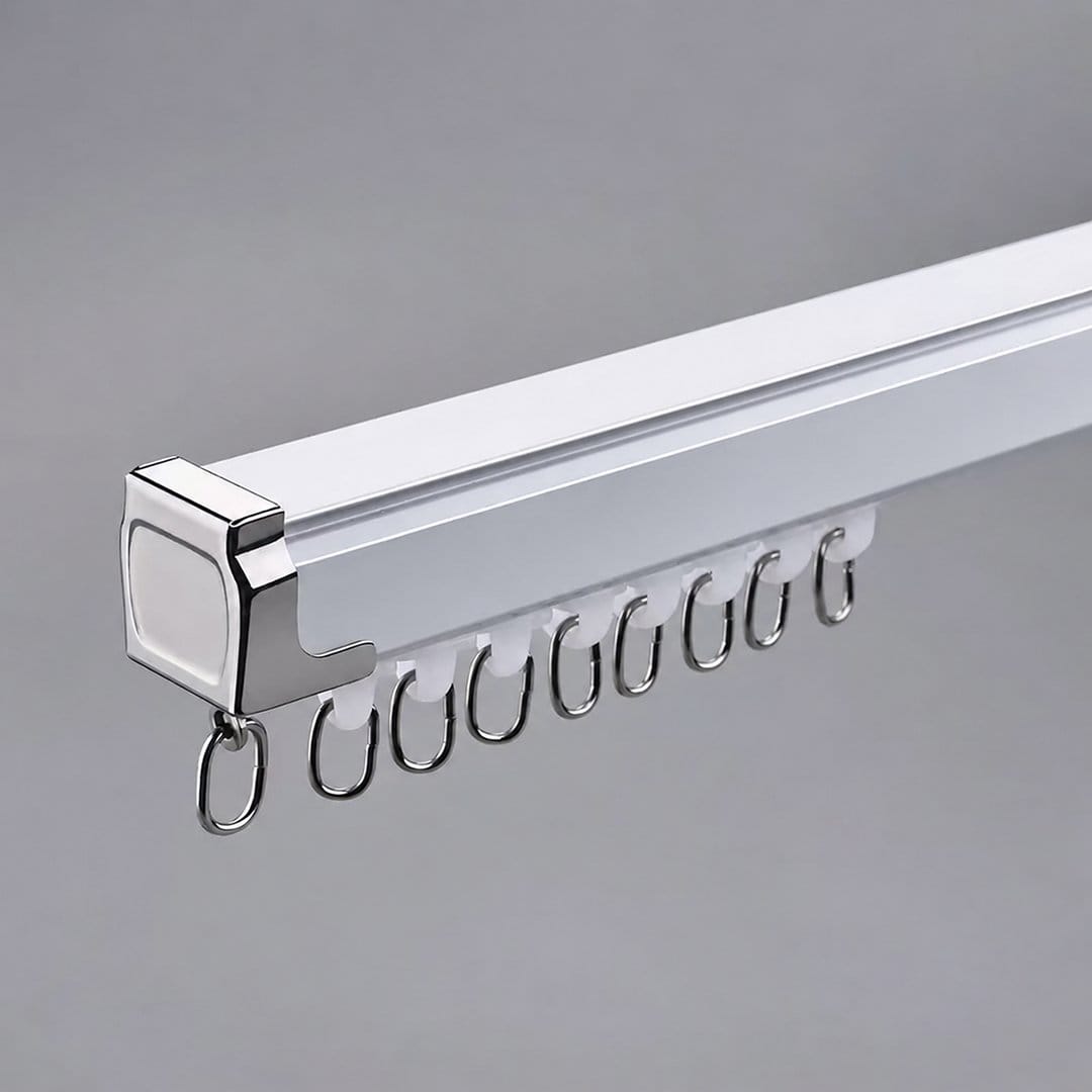 White curtain track with chrome end cap, gliders and metal rings